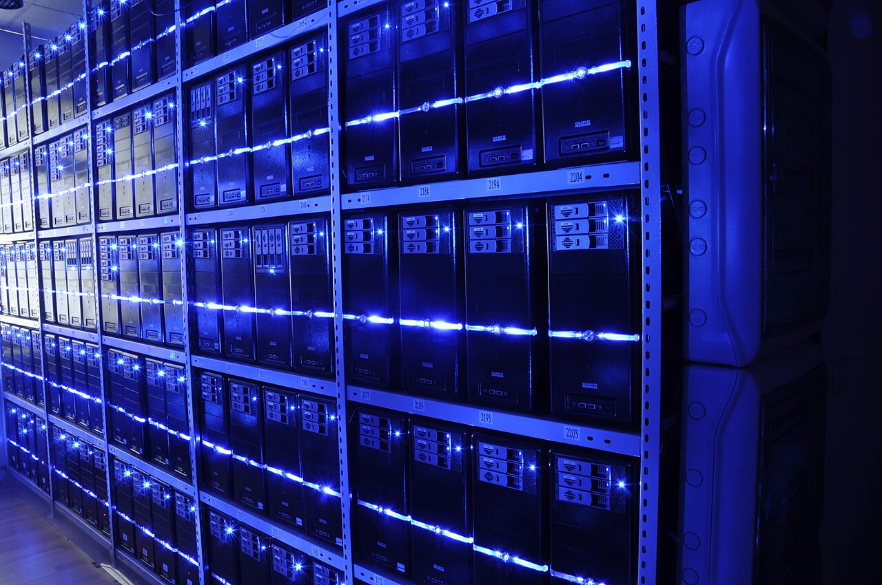 Rows of illuminated server racks in a secure data center